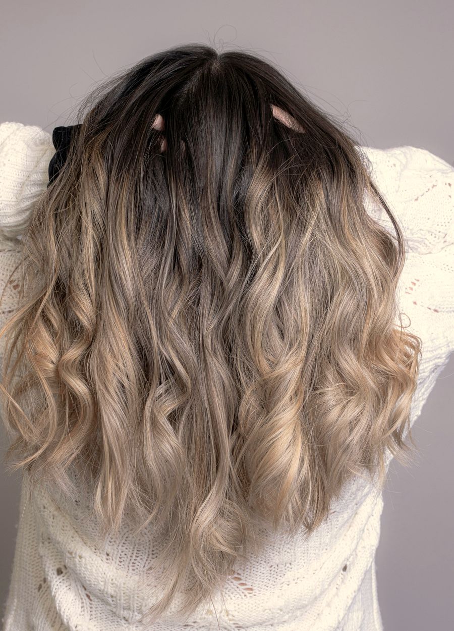 Long balayage waves, dark at the roots and pale blonde at the ends